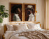 a bedroom with a large bed, two framed portraits of a man and a woman, and a pendant light hanging above the bed.