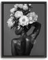 A black and white image of a woman with a large floral arrangement on her head, her back to the camera.