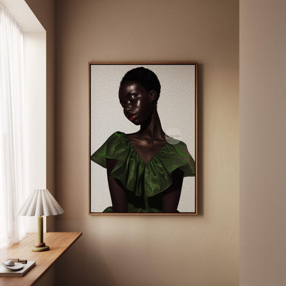 a framed portrait of a woman with dark hair and a green dress, hanging on a wall in a room with a window and a wooden table.