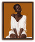 A Black woman in a white digitally textured dress is depicted in a portrait against an honey orange background. Her eyes are closed, in deep thought.