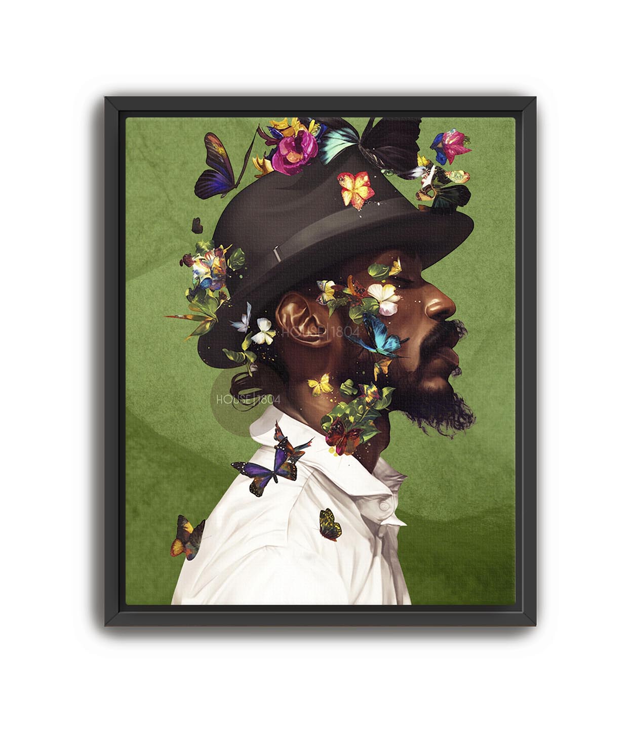 A man wearing a hat with colorful butterflies on it, surrounded by a green background.