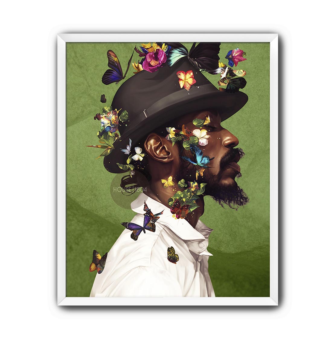 A man wearing a hat with colorful butterflies on it, surrounded by a lush green background.