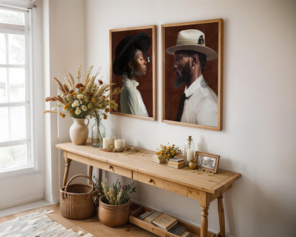 a wooden console table with two framed portraits hanging above it, a vase of flowers, and various decorative items such as a candle holder, a picture frame, and a basket.