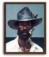 A portrait of a man wearing a cowboy hat with a butterfly resting on his chin. Various blues in the background and on the hat and on the butterfly hence the title Black Man Blues. Brown framed canvas portrait.