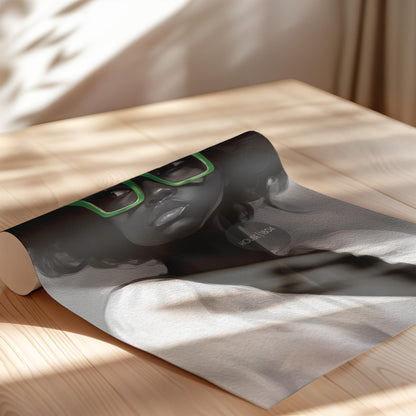 A black and white portrait of a Black woman with curly afro hair wearing large bold green reading glasses. Paper print.